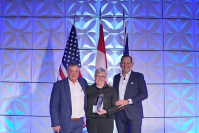 Kelly Sheehan, dealer principal of Sheehan’s Truck Centre accepts the award for Volvo Trucks North America 2022 Canadian Dealer Group of the Year from Peter Voorhoeve, president, Volvo Trucks North America (right) and Paul Kudla, managing director - Canada, Volvo Trucks North America (left). 