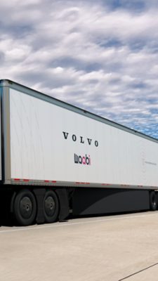 An image of a white Volvo VNL autonomous truck facing slanted slightly towards the camera in bright sunlight