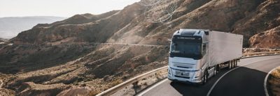 A connected Volvo Truck drives over a bridge in a remote location