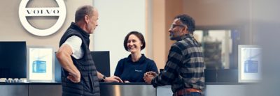 A Volvo representative speaks to a customer while holding a tablet 