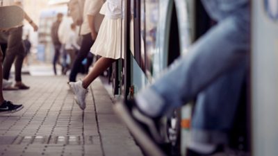 Image of passenger feet boarding an electric city bus.