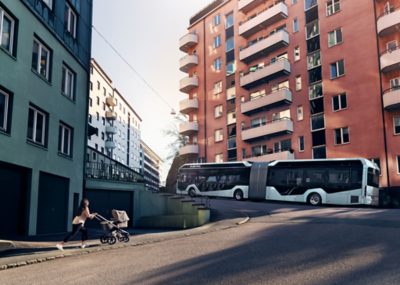 A Volvo 7900 Electric articulated climbing a steep uphill street