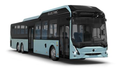 A smiling bus driver behind the steering wheel of a Volvo electric bus