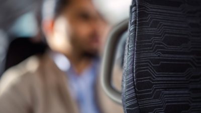 A close-up of the textile upholstery of a Volvo bus seat