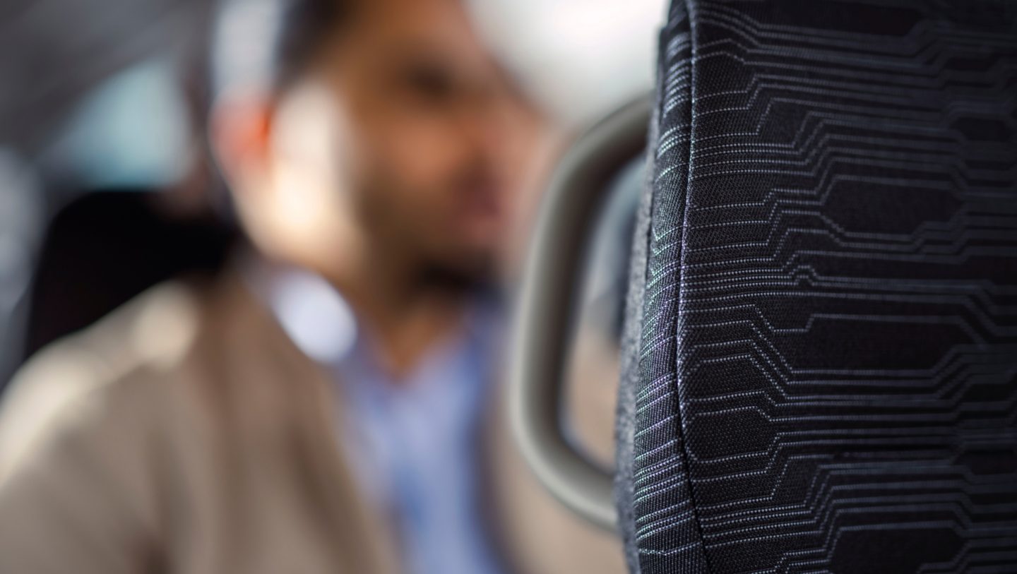 A close-up of the textile upholstery of a Volvo bus seat