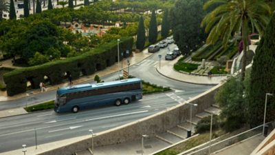 A Volvo 9700 coach on road passing an intersection with multiple lanes