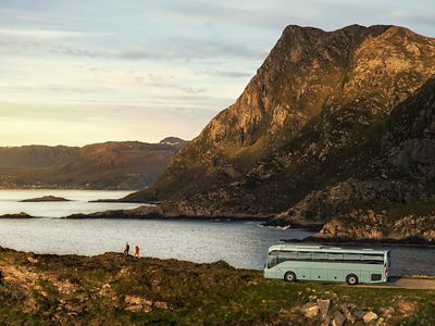 A 9700 coach parked by the ocean.