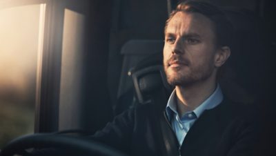 Male bus driver behind the wheel of a Volvo 9700 DD