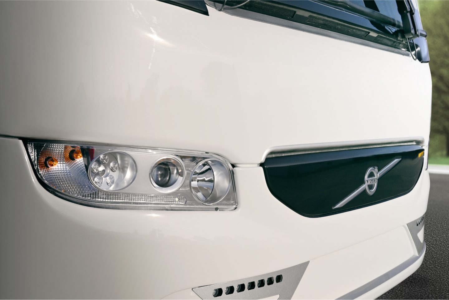 A close-up of the front of a Volvo 9700 coach bus