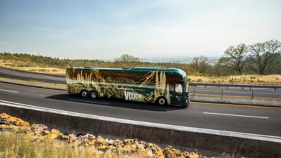 Side view of a Volvo 9800 driving on a motorway.