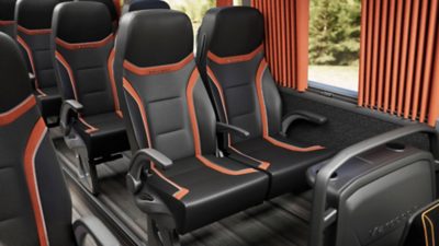 Black and red passenger seats in a Volvo B13R – Marcopolo Paradiso G8