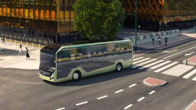 A Volvo BZL Electric city bus making a right-hand turn on a city street