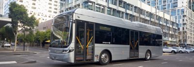 A full hybrid bus at a city bus stop