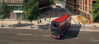 A red Volvo BZL Electric double-decker make a right turn at a crossing