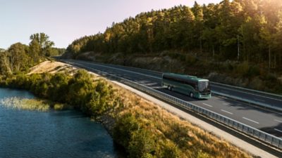 A Volvo BZR Electric – CD coach driving along a lakeside motorway