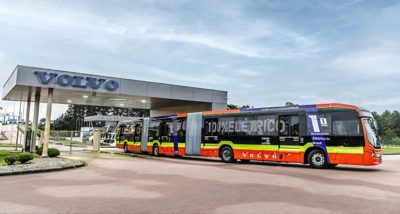 A Volvo BZRT Electric bi-artic bus exits a Volvo dealership