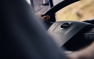 Driver hoolding steering wheel