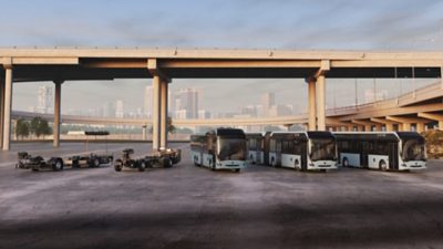 Volvo Buses range of electric bus and electric coach chassis along with complete buses on display in front of a bridge