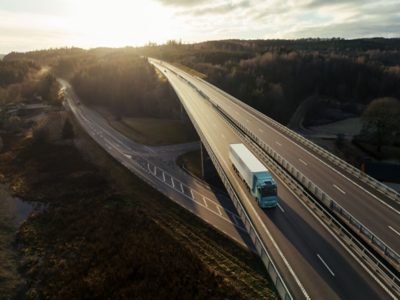 Volvo electric truck on elevated highway at sunrise