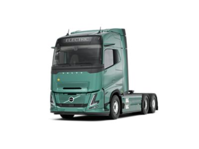 De Volvo FH Aero Electric-truck wordt in een strakke studio-omgeving getoond vanuit een volledig zijprofiel, met een turquoise cabine en een chassis met meerdere assen dat geschikt is voor diverse carrosserieconfiguraties. De afbeelding toont details van het exterieurontwerp, aerodynamische cabinelijnen en chassiscomponenten.