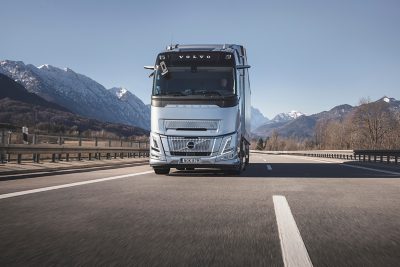 Volvo FH Aero gas-powered driving on road in desert environment
