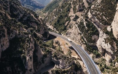 Truck driving on road through valley