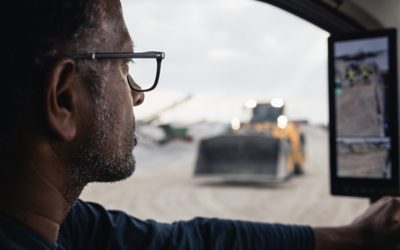 Man with glasses looking at camera monitor system