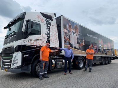 Geert van Eijk (directeur transport en distributie Nedcargo) overhandigt de sleutels van de Volvo FH LNG aan de chauffeurs van de pendeldienst: Eddy Roos en Jan-Willem van Zeitveld.
