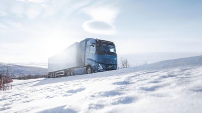 Sideview of  a Volvo FH hydrogen truck on a snow-covered street