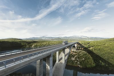 Volvo FH with I-save truck driving on a bridge, front view