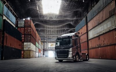 Volvo FM inside a building, surrounded by containers 