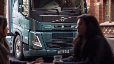 Volvo FM electric in city with women in foreground