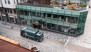 A Volvo electric refuse truck driving.