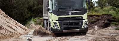 Volvo FMX driving by a harbor