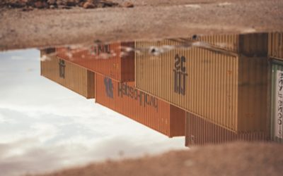 Containers reflecting in a puddle of water