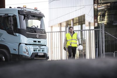 Volvo FMX Electric truck with driver on construction site