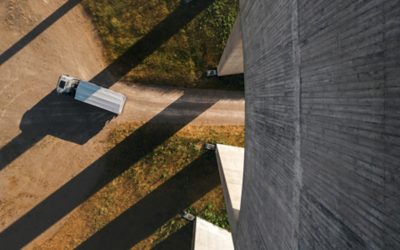 A Volvo FMX truck, viewed from above, executes a right turn