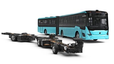 Studio image of a high-floor articulated electric bus chassis and corresponding complete bus