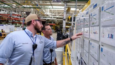 Two man analyzing the graph on production floor | Volvo Group
