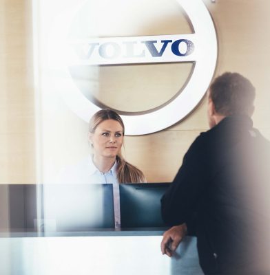 Customer and Volvo sales staf at dealership