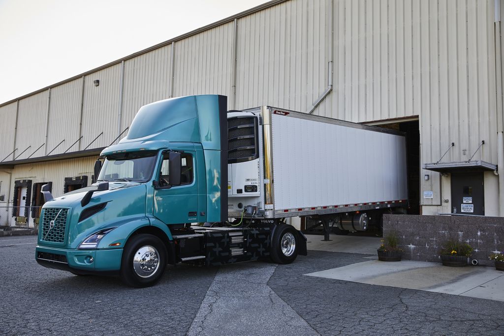 Volvo VNR Electric 4x2 Tractor with Reefer Trailer Parking at Loading Dock