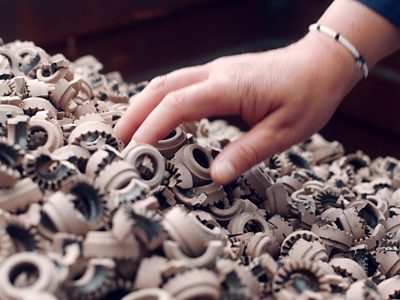 A hand digging in waste saved from landfill