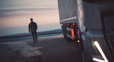  Truck driver walking towards a parked Volvo FH truck.